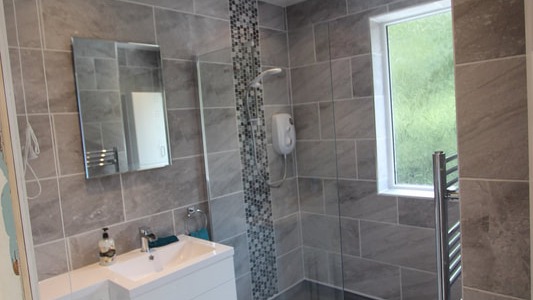 grey-tiled-walk-in-shower-with-white-suite-16x9-1 What's In (and What's Not) When You Convert to a Shower Room